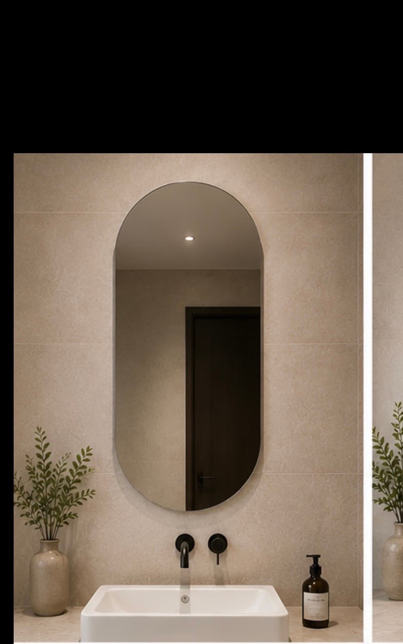 Modern capsule oval frameless bathroom mirror mounted with backlit glow above a white rectangle sink